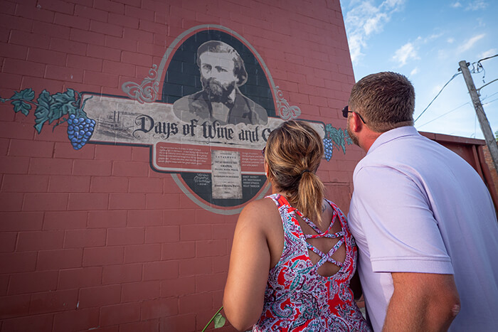 Couple Looking at George Husmann Mural in Hermann, MO